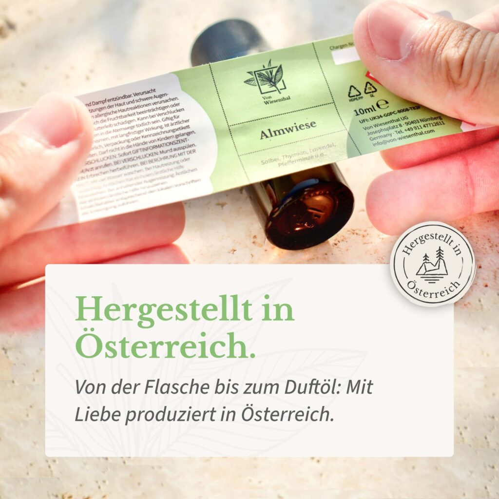 Ein naturreines ätherisches Duftöl Almwiese wird von Hand hergestellt und etikettiert.